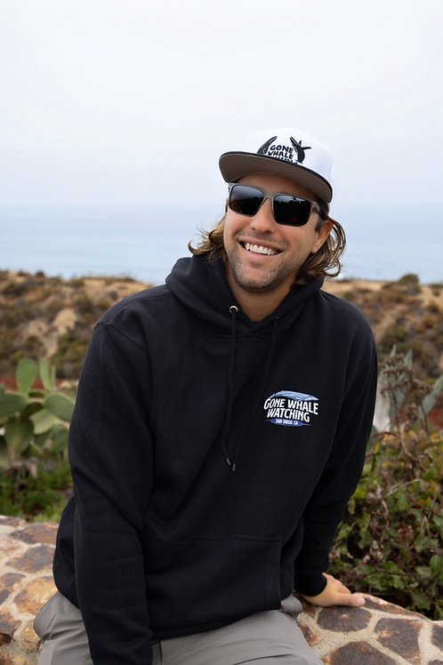 Capt. Dom in a Gone Whale Watching hoodie on a San Diego coastal bluff